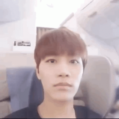 Young Man Making Funny Face on Airplane