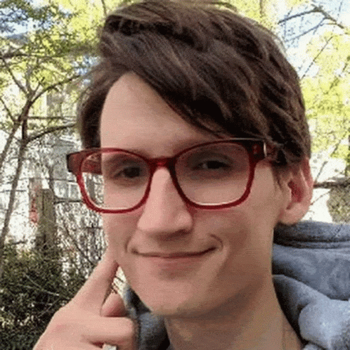 Young Man Making Funny Face With Glasses and Blue Hoodie