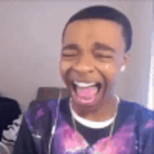 Young Man Making Funny Face With Tongue Out Wearing Headphones