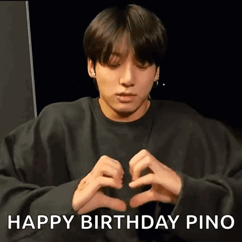Young Man Making Heart Shape With Hands in Black Sweatshirt