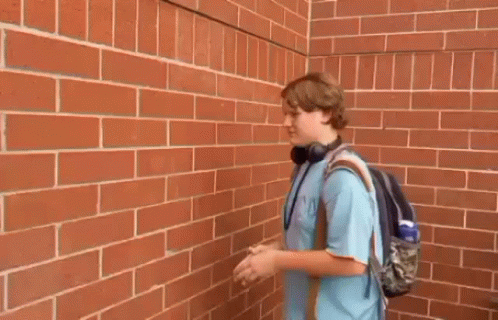 Young Man Outstretched Hands Brick Wall