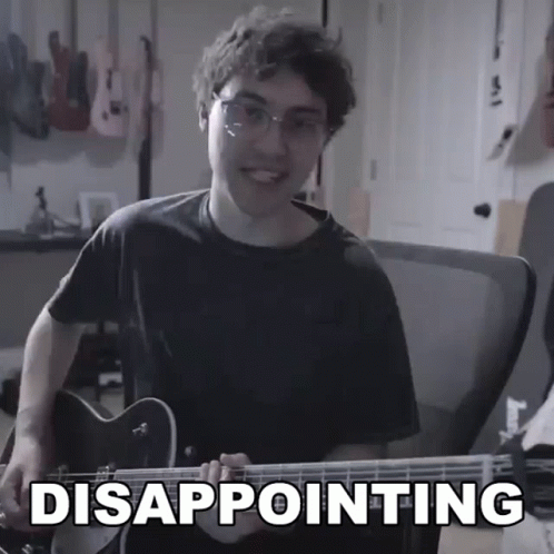 Young Man Playing Guitar With Disappointing