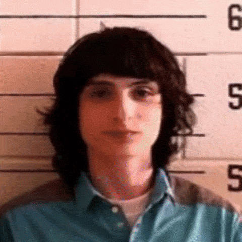 Young Man Posing in Front of Police Line