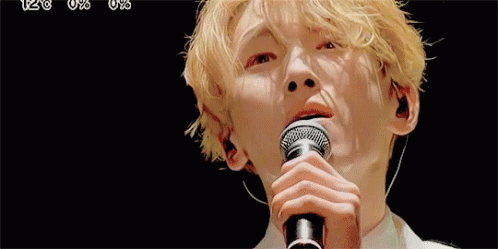 Young Man Singing Into Microphone