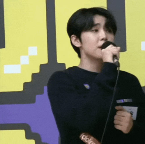 Young Man Singing Into Microphone
