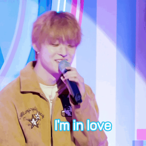 Young Man Singing Into Microphone I'm in Love