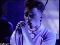 Young Man Singing Into Microphone Purple Shirt GIF