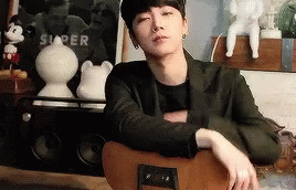 Young Man Sitting Crossed Arms Guitar
