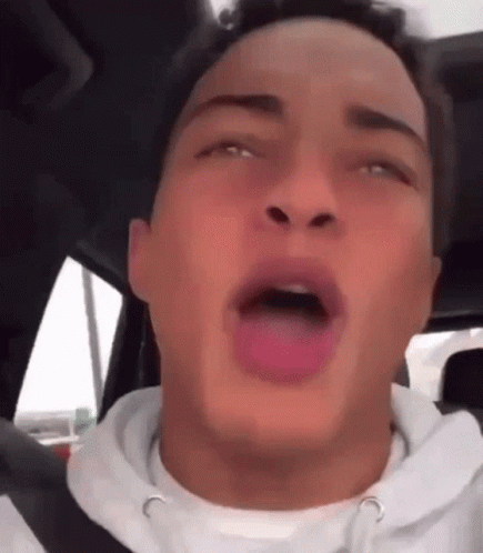 Young Man Sitting In Car With Tongue Hanging Out GIF
