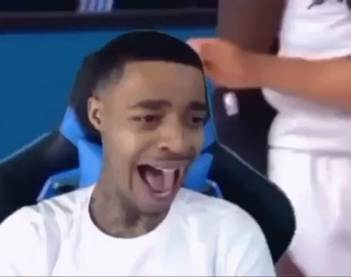 Young Man Sitting in Chair With Tongue Out