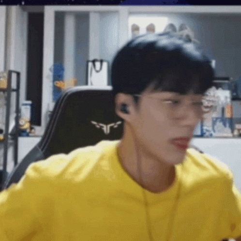 Young Man Sitting With Glasses And Headphones GIF
