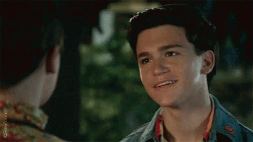 Young Man Smiling at Friend in Floral Shirt
