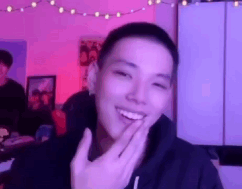 Young Man Smiling Covering Mouth