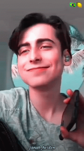 Young Man Smiling Holding Cell Phone Janah Helden