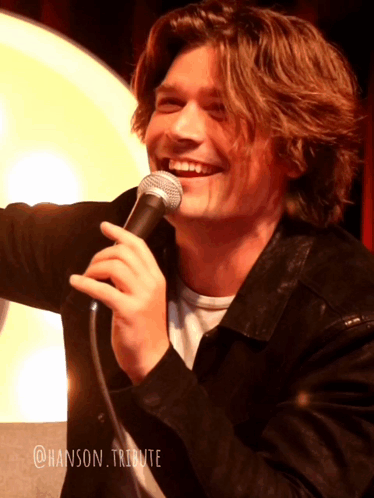 Young Man Smiling Holding Microphone @hanson Tribute