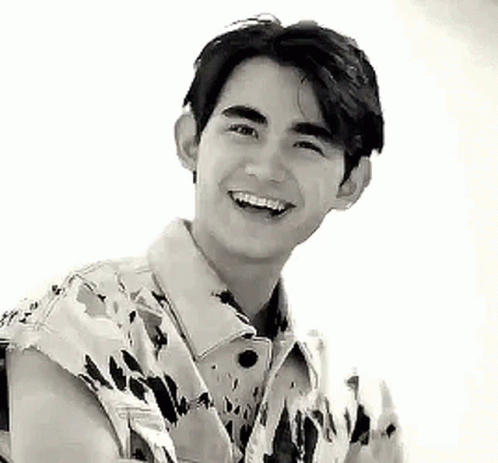 Young Man Smiling in Camouflage Jacket