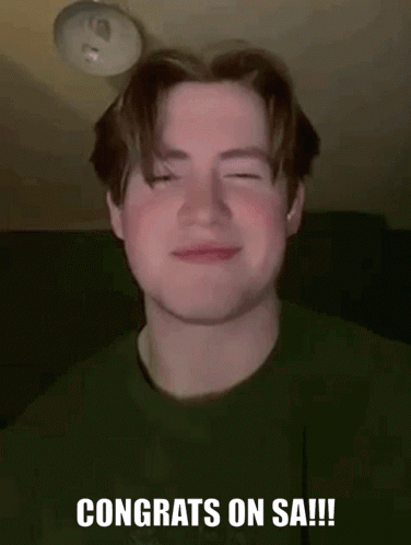 Young Man Smiling in Green Shirt
