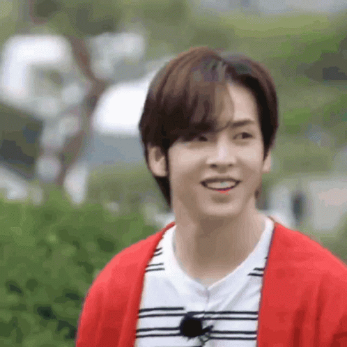 Young Man Smiling in Red Cardigan and Striped Shirt