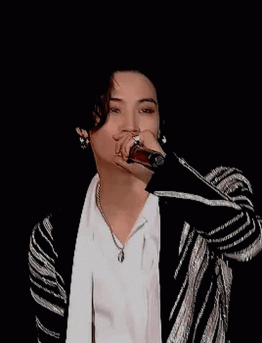 Young Man Smiling in White Shirt and Black-and-White Jacket