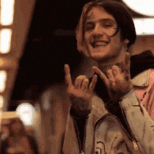 Young Man Smiling Making Peace Sign GIF
