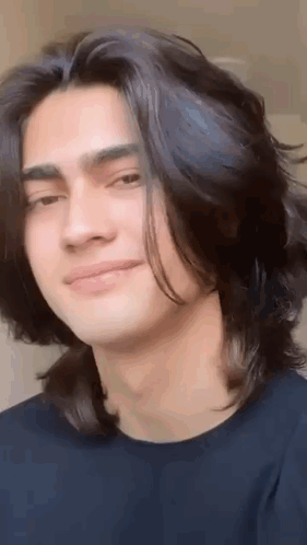 Young Man Smiling with Long Black Hair