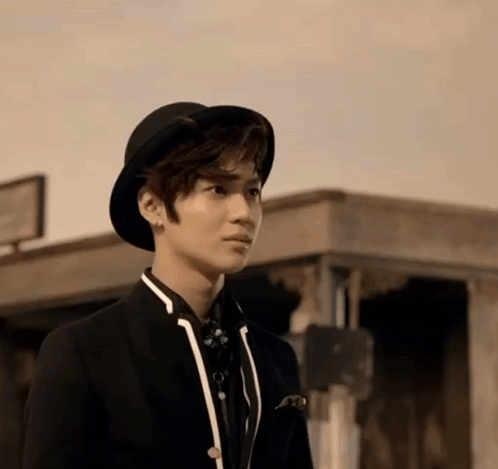 Young Man Standing in Hat and Suit
