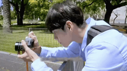Young Man Taking Picture With Camera