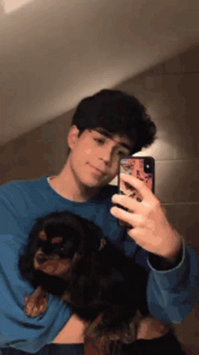 Young Man Taking Selfie Holding Dog
