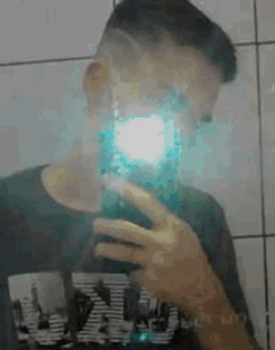 Young Man Taking Selfie in Mirror