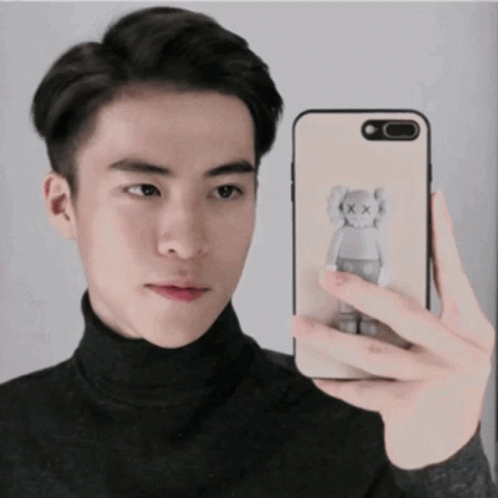 Young Man Taking Selfie With Kaws Bear Phone