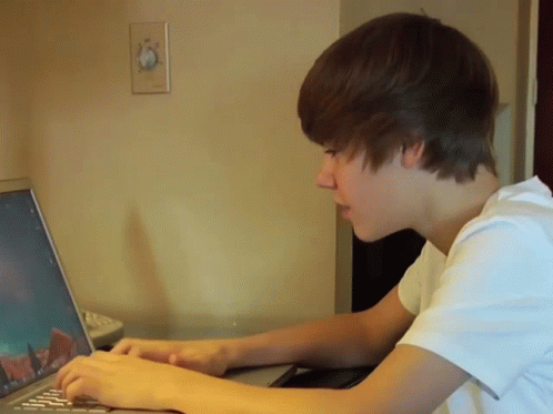 Young Man Typing On Laptop GIF