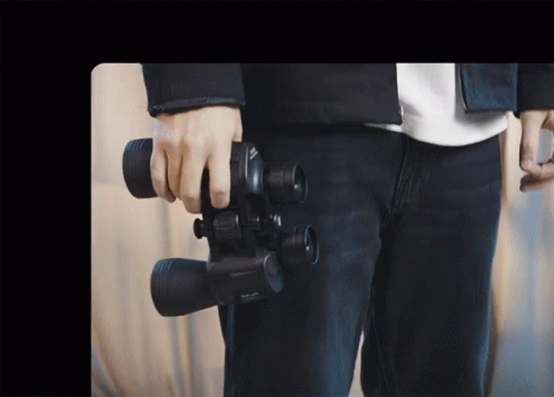 Young Man Using High Resolution Binoculars GIF