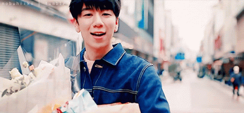 Young Man Walking with Bouquet Smiling