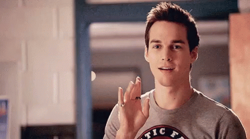Young Man Waving in Kitchen