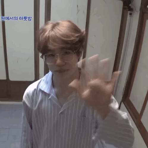 Young Man Waving in Striped Shirt