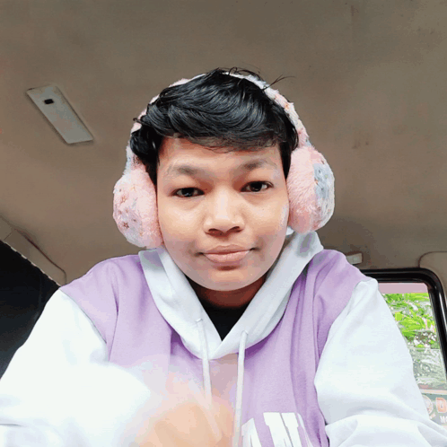 Young Man Wearing Ear Muffs and Purple Hoodie