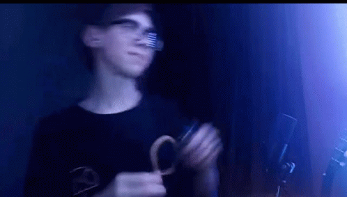 Young Man Wearing Glasses Holding Scissors