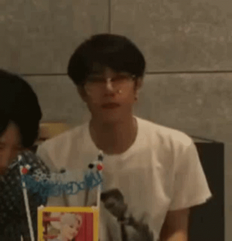 Young Man Wearing Glasses Sitting At Table GIF