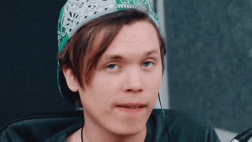 Young Man Wearing Green Bandana and Baseball Cap