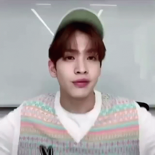 Young Man Wearing Hat and Vest Making Face