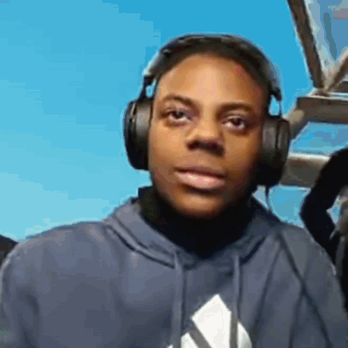 Young Man Wearing Headphones and Blue Sweatshirt