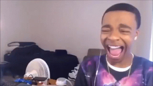 Young Man Wearing Headphones Laughing