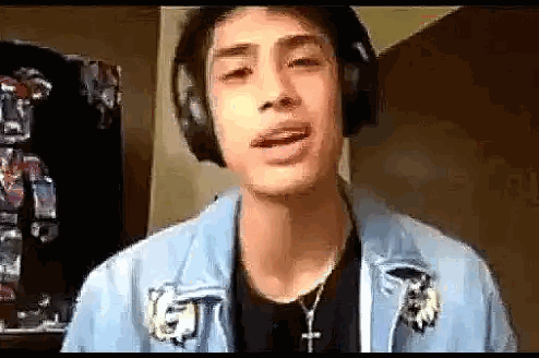Young Man Wearing Headphones Making Face
