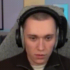 Young Man Wearing Headphones Sitting In Chair GIF