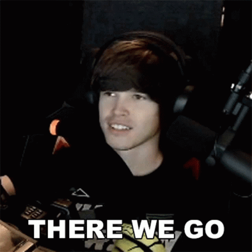 Young Man Wearing Headphones Sitting in Front of Microphone