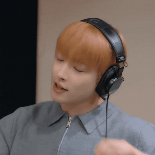 Young Man Wearing Headphones With L On Left GIF