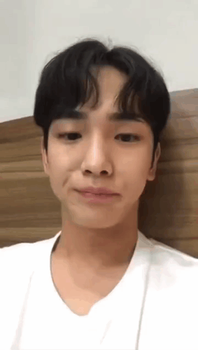 Young Man White Shirt Making Funny Face Against Wall