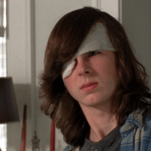 Young Man With Bandage on Eye Looking at Camera