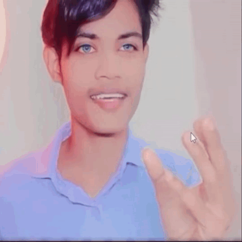 Young Man With Blue Eyes Giving OK Sign