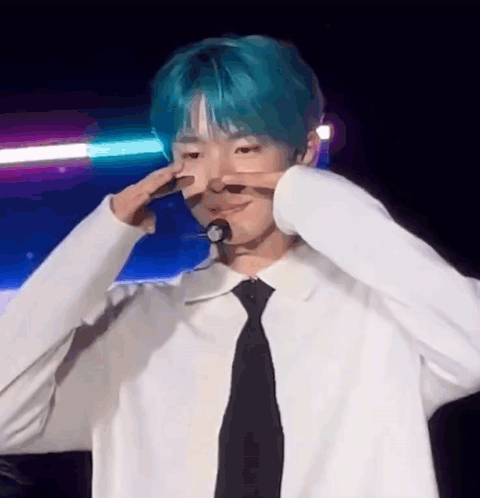 Young Man With Blue Hair Making Peace Sign